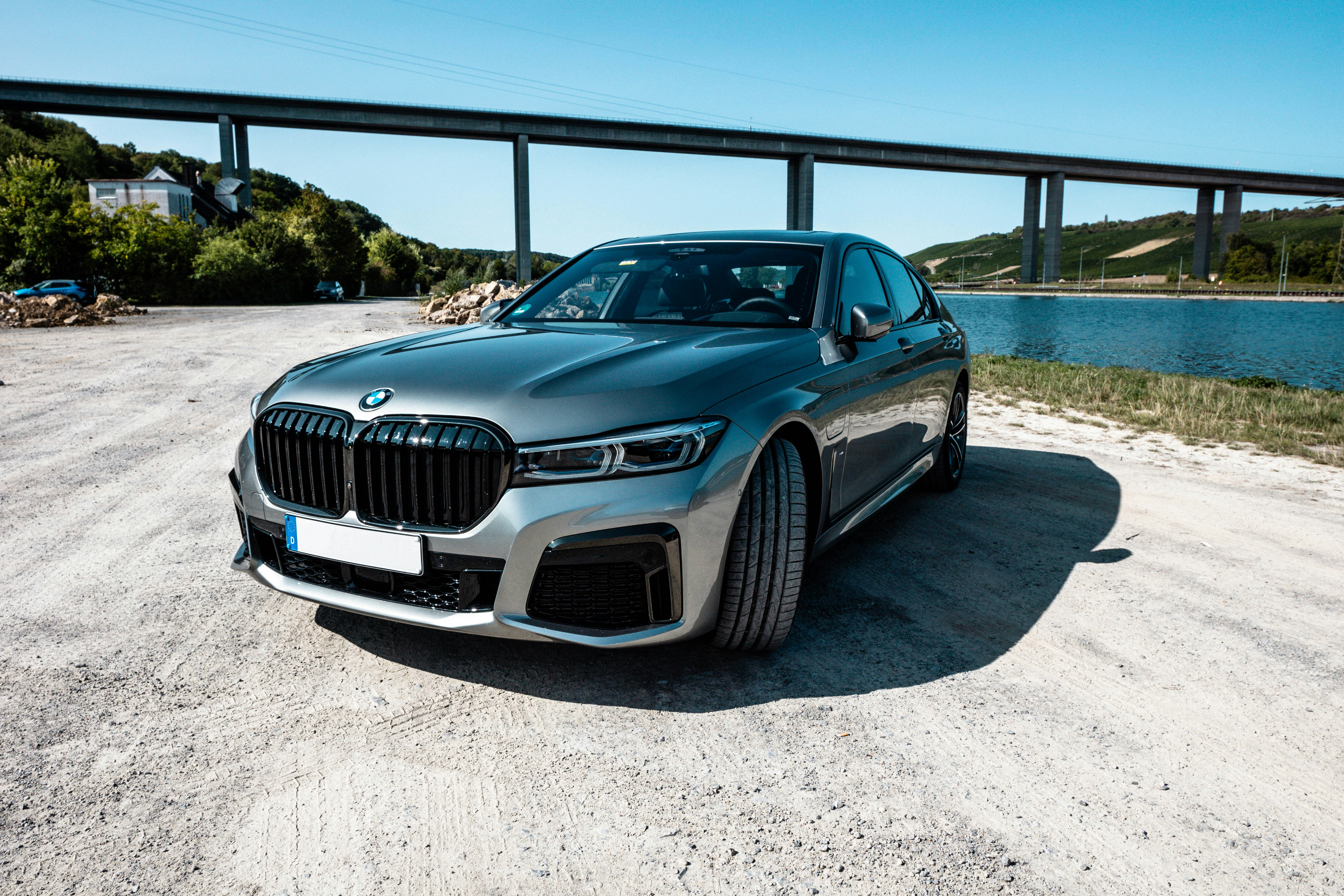 blue bmw m 3 coupe parked on gray sand during daytime